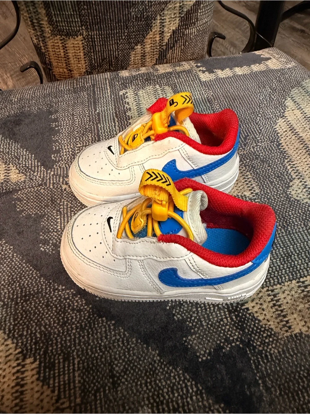 Nike White Kids Sneakers with Red Lining, Yellow Laces & Blue Accents